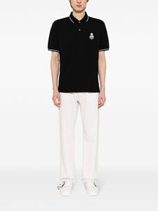 musiumdiv. Musium Div. Poloshirt met geborduurd logo - Zwart